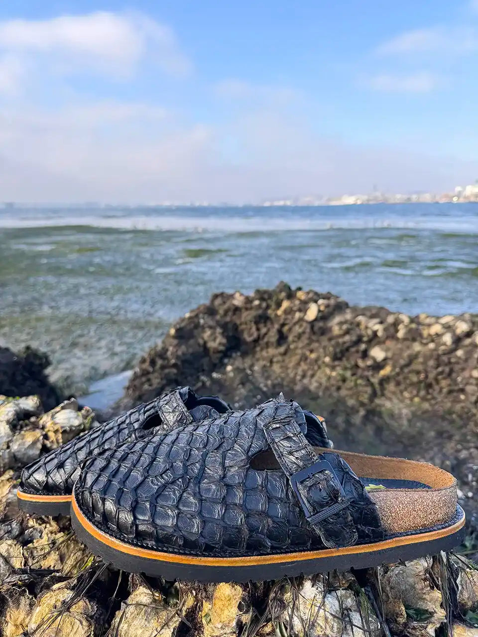 Botas Hasta La Muerte black pirarucu leather clogs with cork footbed and Vibram sole handcrafted in León Mexico.
