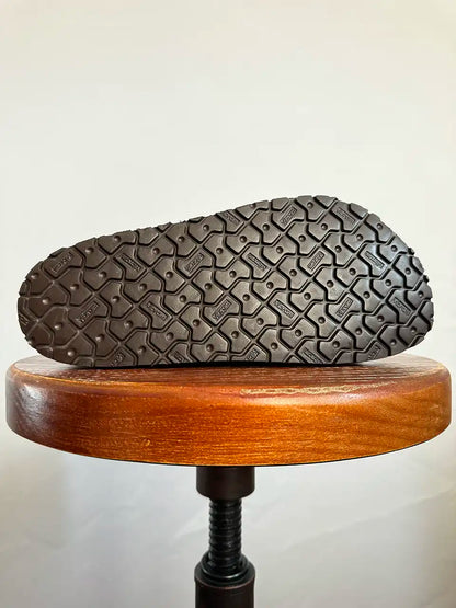 Botas Hasta La Muerte brown and white cowhide huaraches with cork footbed and Vibram sole handcrafted in León Mexico.