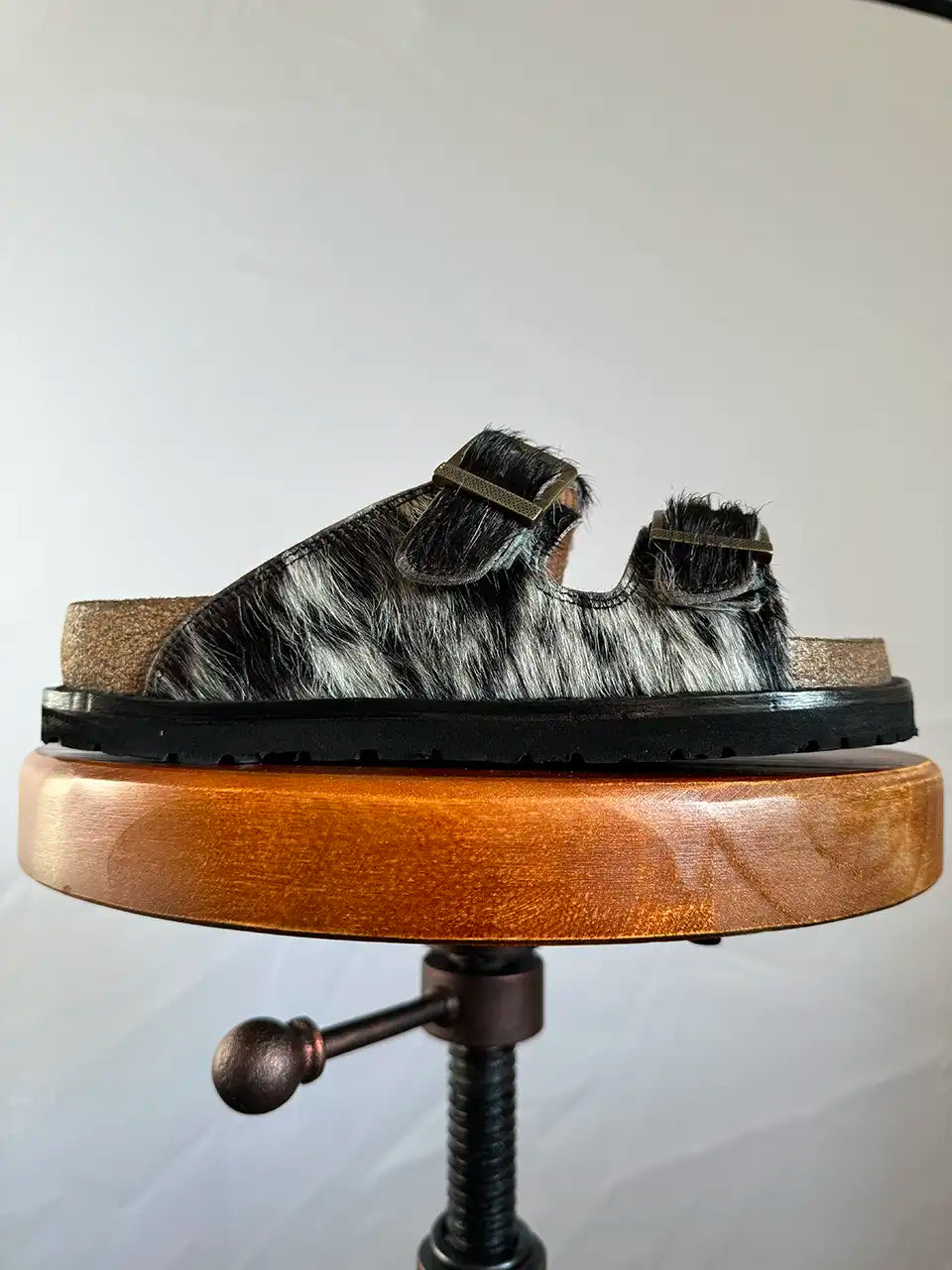 Botas Hasta La Muerte black and white cowhide huaraches with cork footbed and Vibram sole handcrafted in León Mexico.