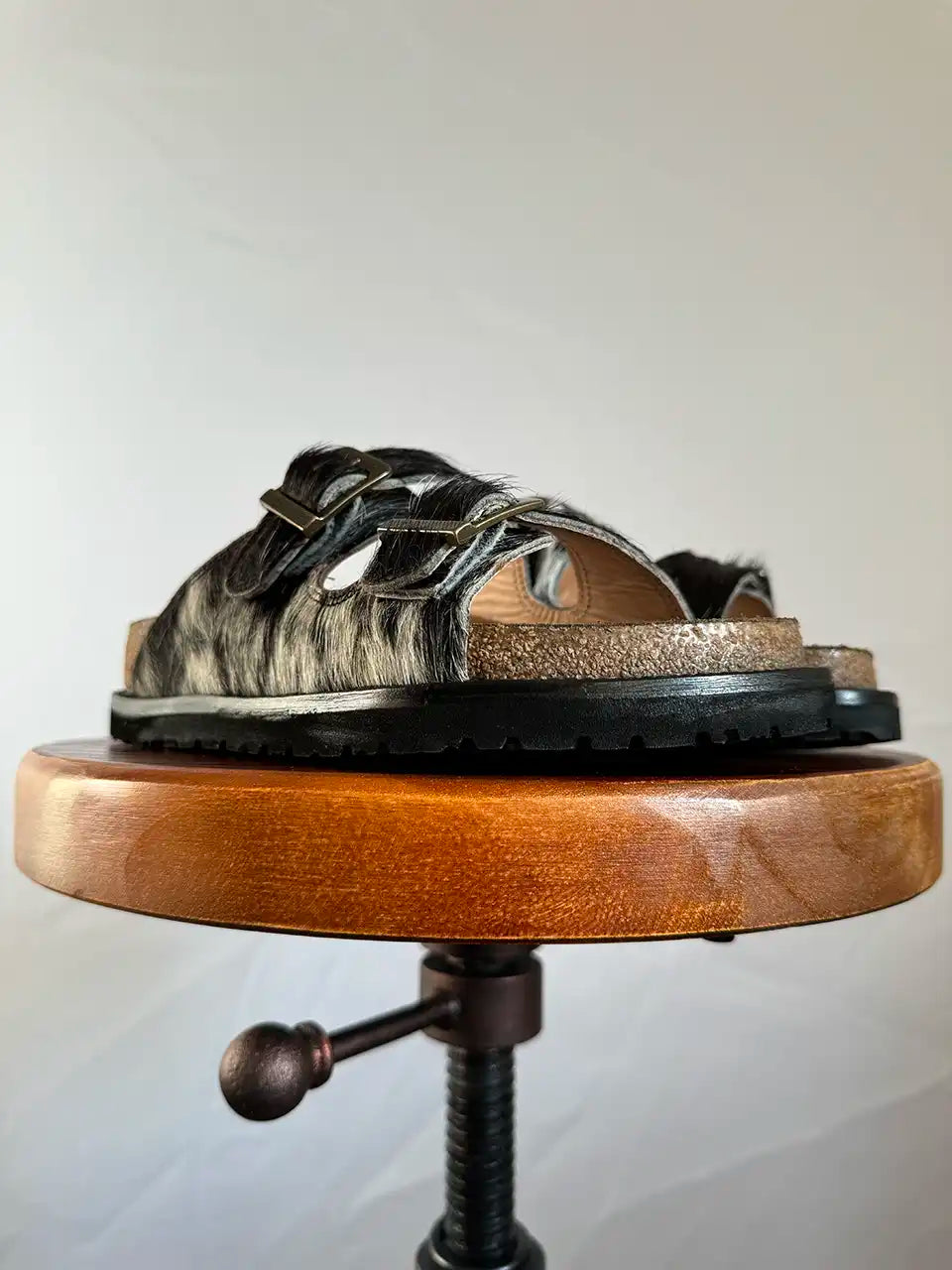 Botas Hasta La Muerte black and white cowhide huaraches with cork footbed and Vibram sole handcrafted in León Mexico.