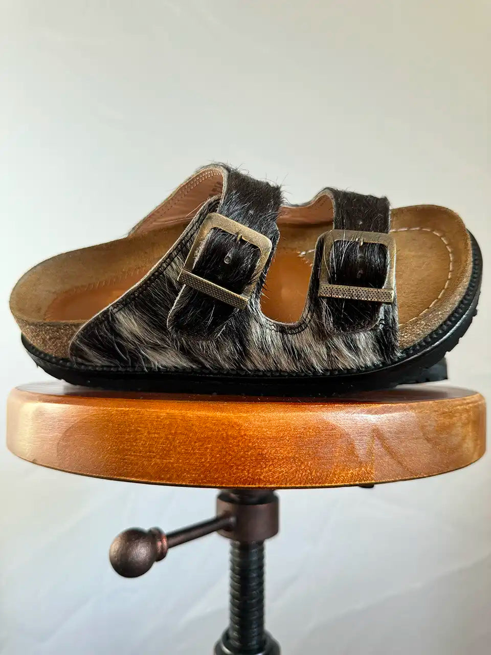 Botas Hasta La Muerte black and white cowhide huaraches with cork footbed and Vibram sole handcrafted in León Mexico.