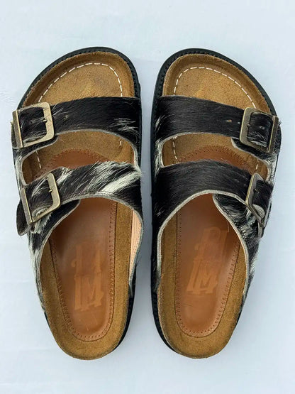 Botas Hasta La Muerte black and white cowhide huaraches with cork footbed and Vibram sole handcrafted in León Mexico.