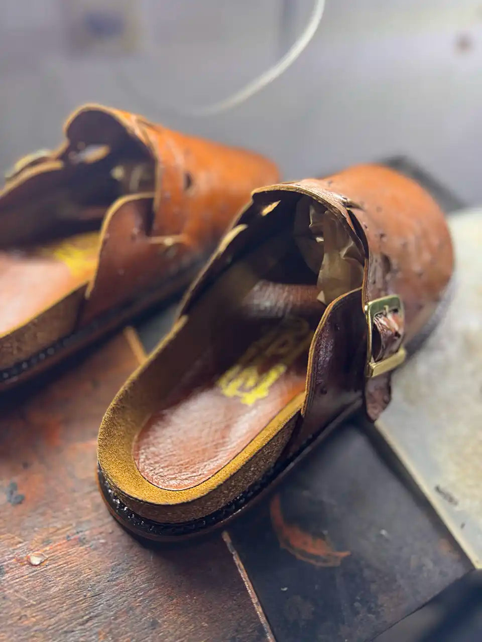 Botas Hasta La Muerte cognac brown full quill ostrich leather clogs with cork footbed and Vibram soles handcrafted in León Mexico.