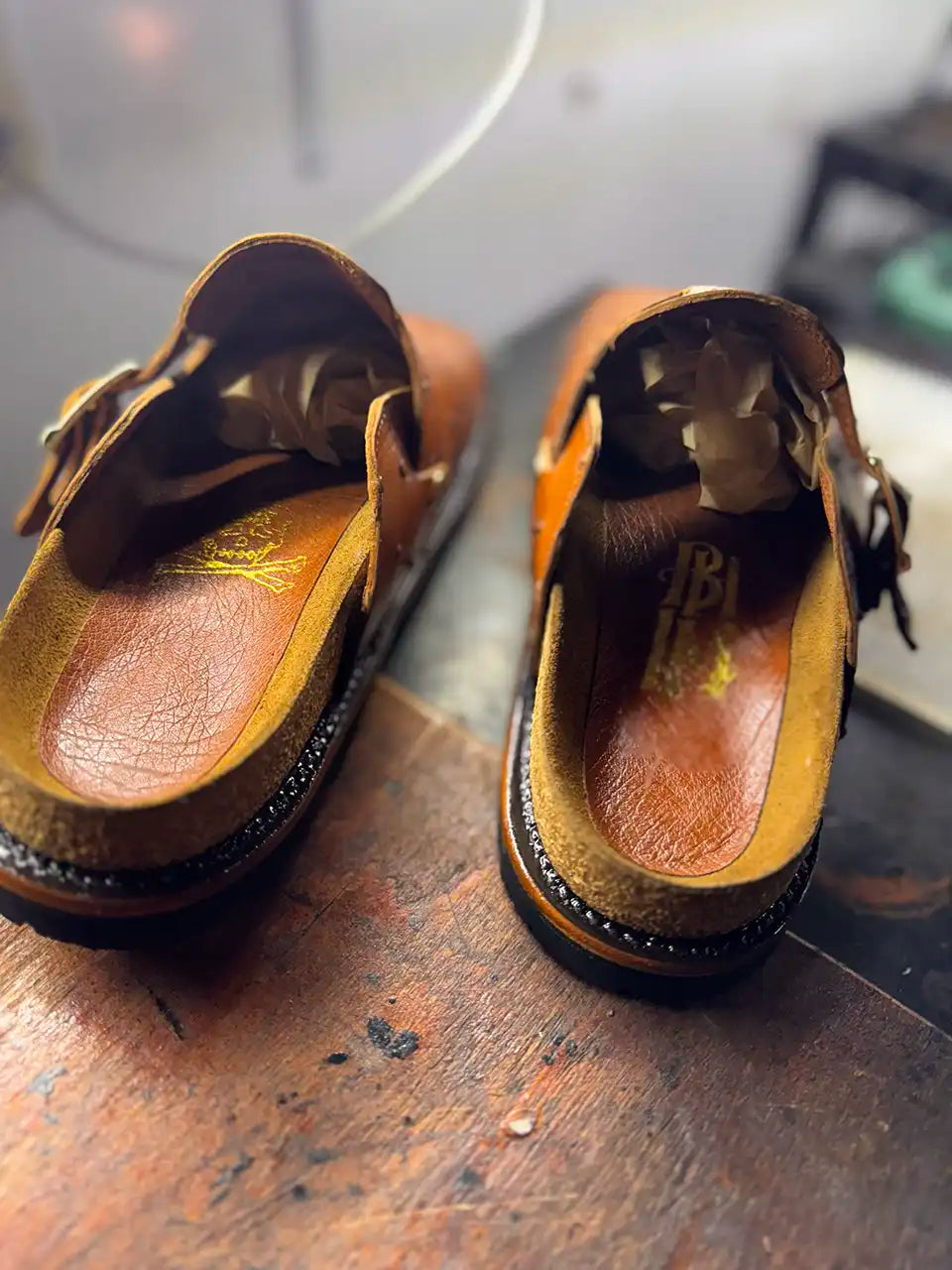 Botas Hasta La Muerte cognac brown full quill ostrich leather clogs with cork footbed and Vibram soles handcrafted in León Mexico.