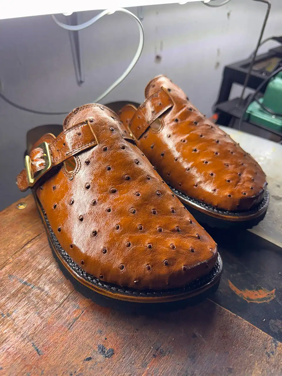Botas Hasta La Muerte cognac brown full quill ostrich leather clogs with cork footbed and Vibram soles handcrafted in León Mexico.