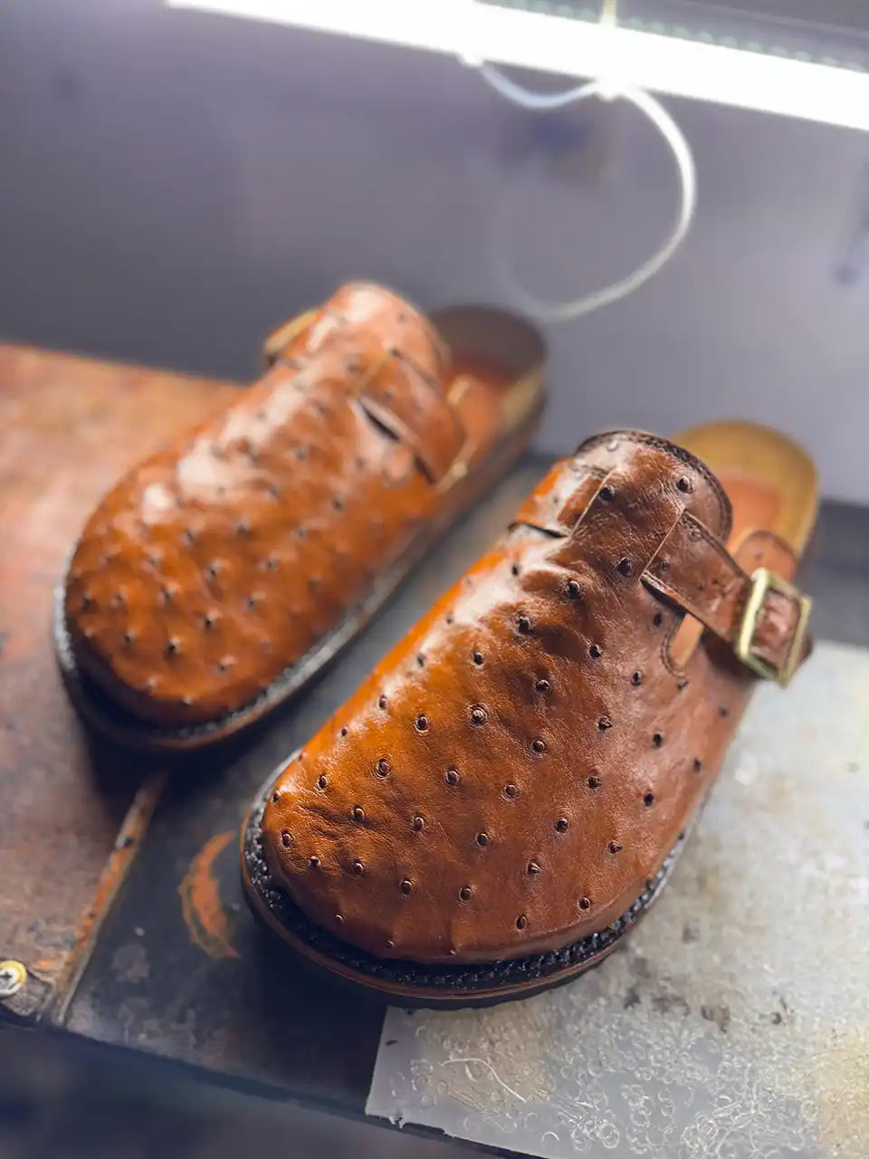 Botas Hasta La Muerte cognac brown full quill ostrich leather clogs with cork footbed and Vibram soles handcrafted in León Mexico.