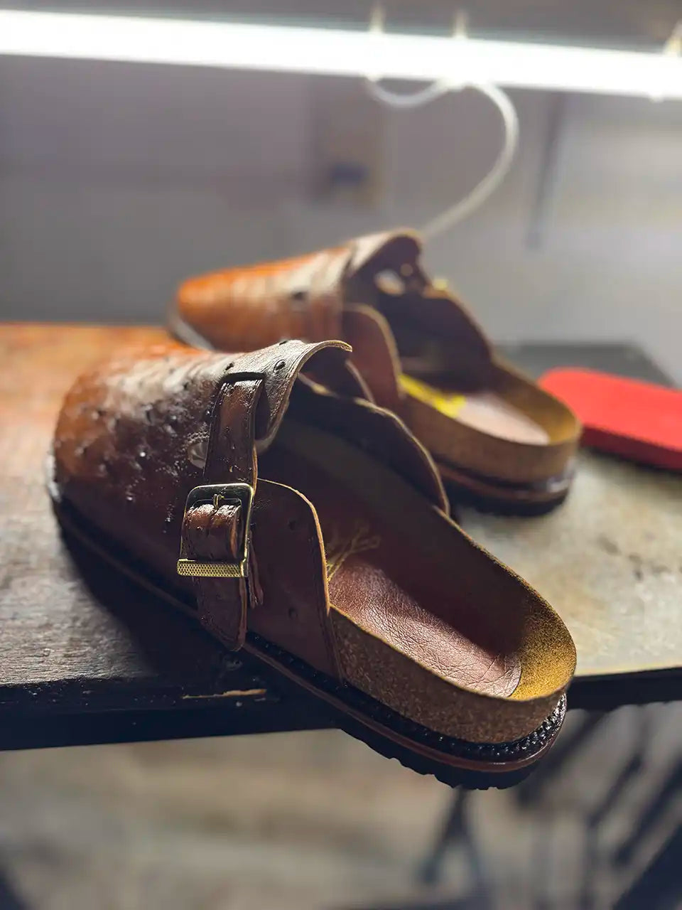 Botas Hasta La Muerte cognac brown full quill ostrich leather clogs with cork footbed and Vibram soles handcrafted in León Mexico.