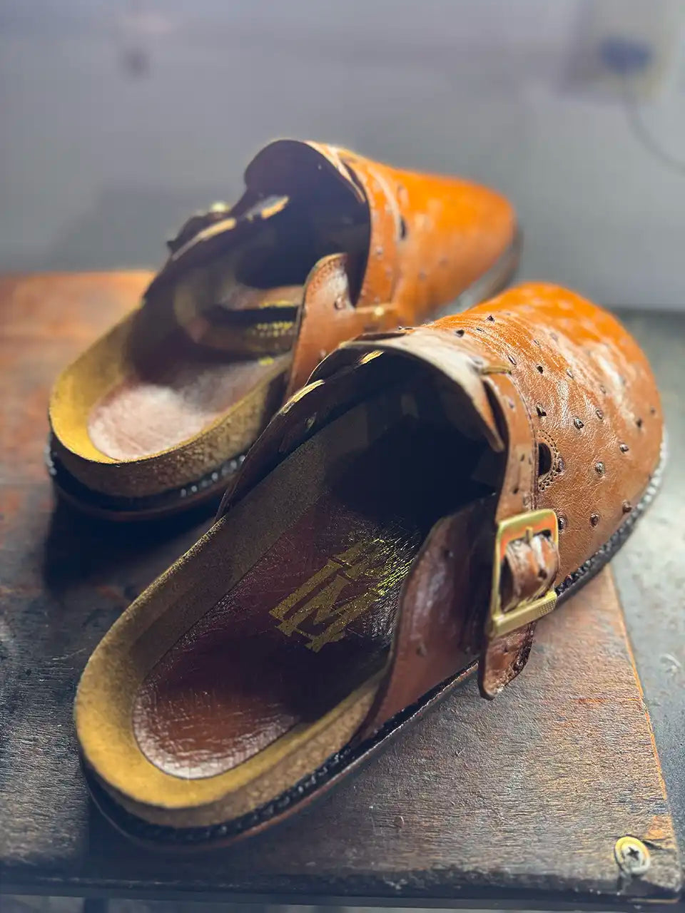 Botas Hasta La Muerte cognac brown full quill ostrich leather clogs with cork footbed and Vibram soles handcrafted in León Mexico.