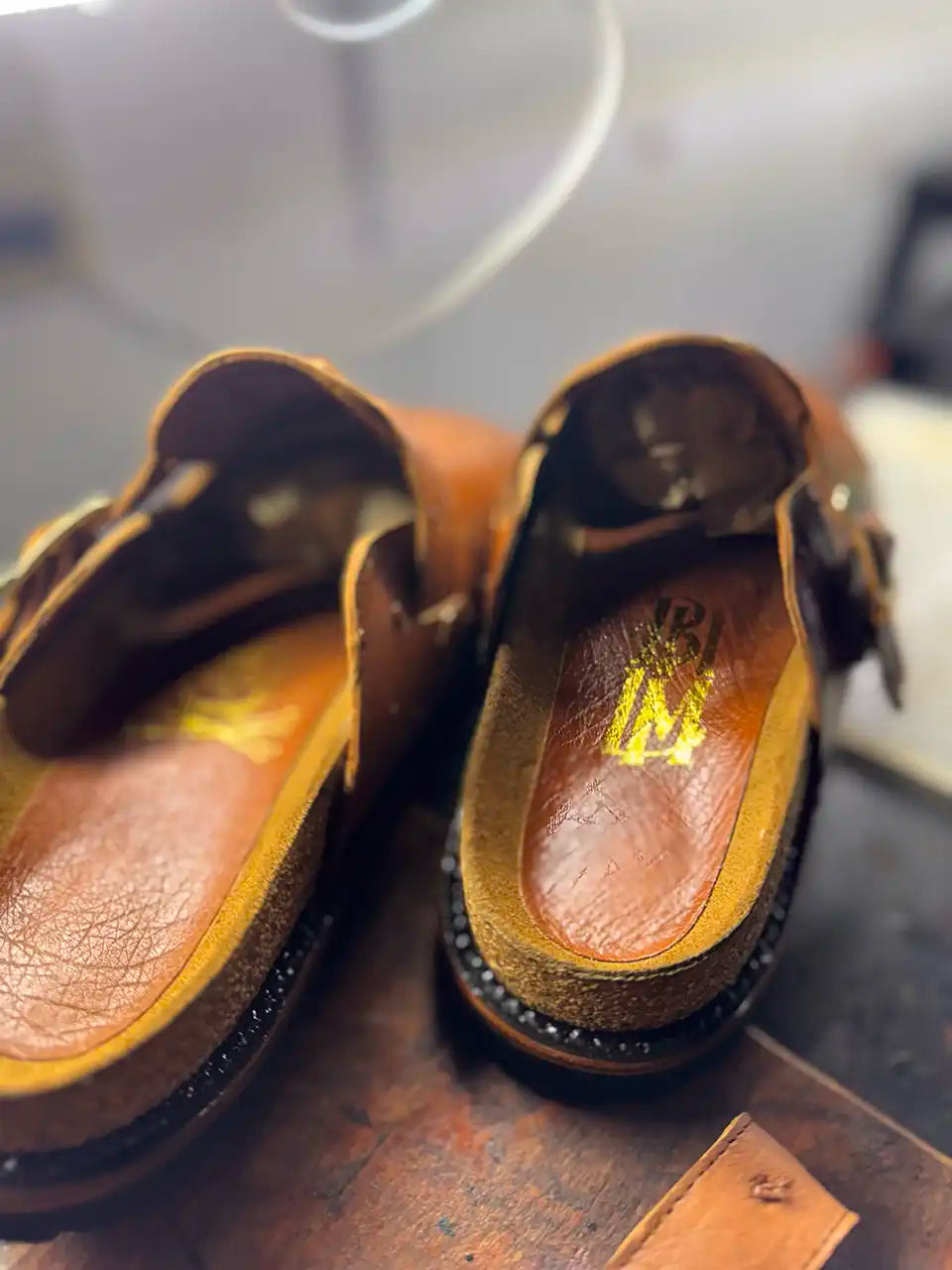 Botas Hasta La Muerte cognac brown full quill ostrich leather clogs with cork footbed and Vibram soles handcrafted in León Mexico.