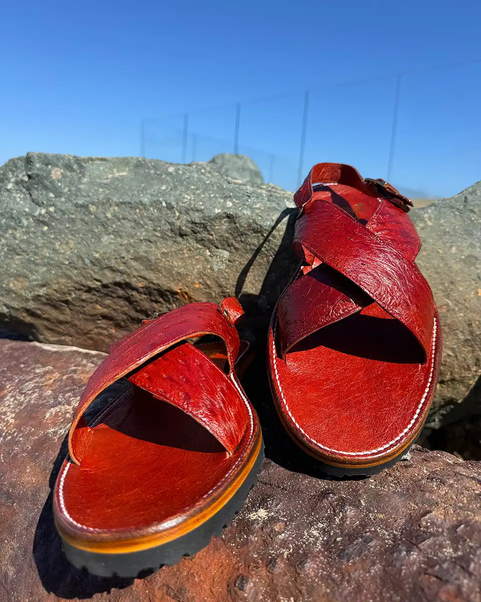 Botas Hasta La Muerte Cross Strap Huaraches in burnt red ostrich leather with Vibram soles handcrafted in León Mexico.