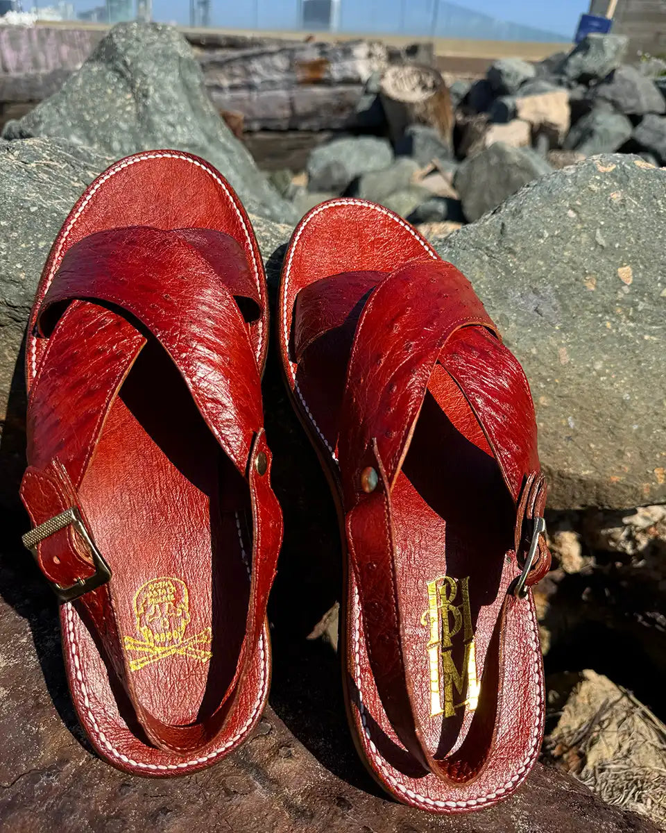Botas Hasta La Muerte Cross Strap Huaraches in burnt red ostrich leather with Vibram soles handcrafted in León Mexico.