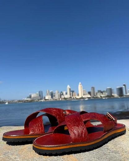 Botas Hasta La Muerte Cross Strap Huaraches in burnt red ostrich leather with Vibram soles handcrafted in León Mexico.
