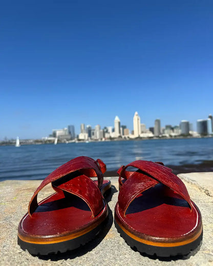 Botas Hasta La Muerte Cross Strap Huaraches in burnt red ostrich leather with Vibram soles handcrafted in León Mexico.