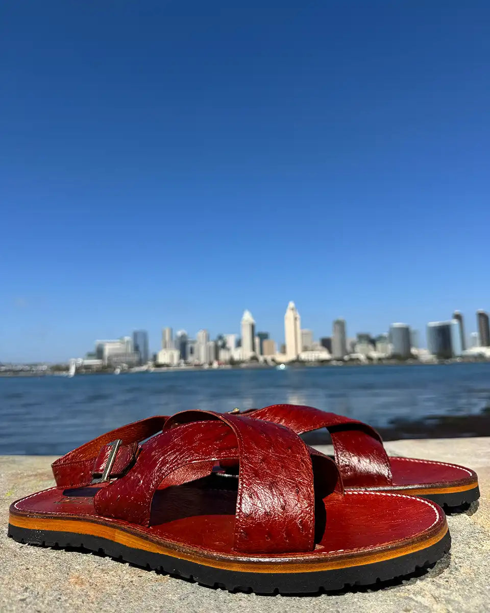 Botas Hasta La Muerte Cross Strap Huaraches in burnt red ostrich leather with Vibram soles handcrafted in León Mexico.
