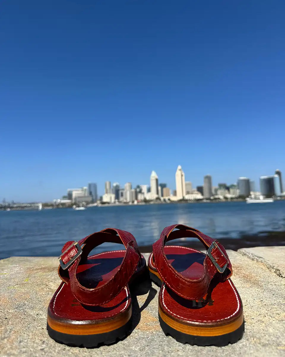 Botas Hasta La Muerte Cross Strap Huaraches in burnt red ostrich leather with Vibram soles handcrafted in León Mexico.