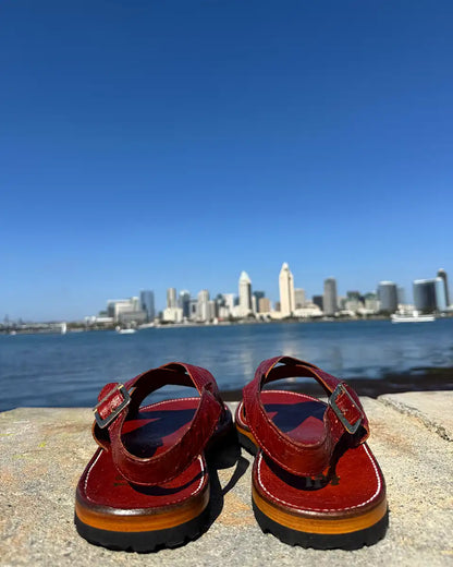 Botas Hasta La Muerte Cross Strap Huaraches in burnt red ostrich leather with Vibram soles handcrafted in León Mexico.